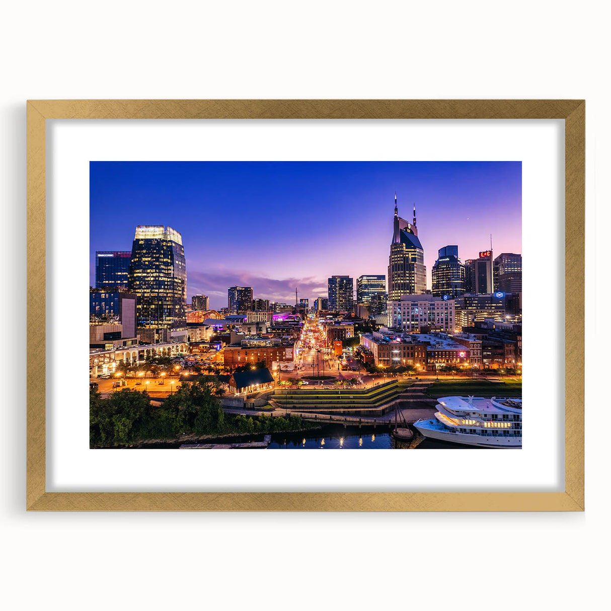 Extra large abstract art print depicting a textured Nashville skyline in muted gold and blue tones, framed with a gold mat.