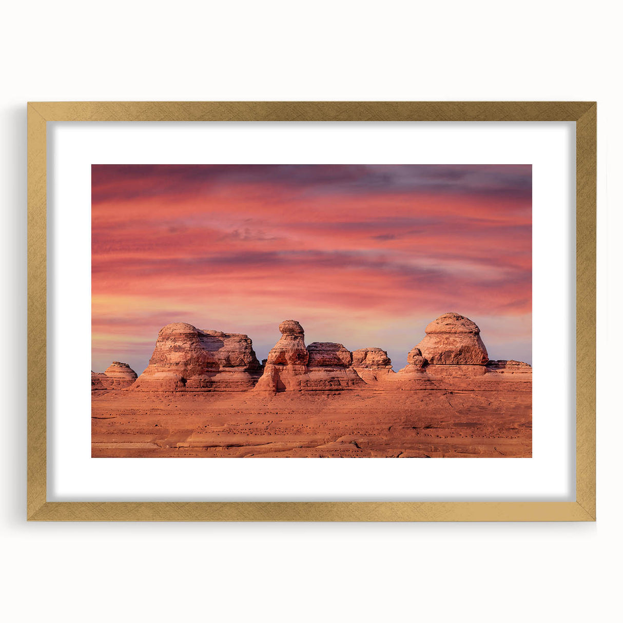 Extra large abstract art print of Utah's Arches in muted earth tones on a textured canvas, framed in gold.