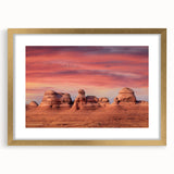 Extra large abstract art print of Utah's Arches in muted earth tones on a textured canvas, framed in gold.
