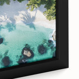Framed canvas artwork showcasing a vibrant beach landscape with blue skies and golden sand, ideal for home decor and enhancing coastal-themed interiors.