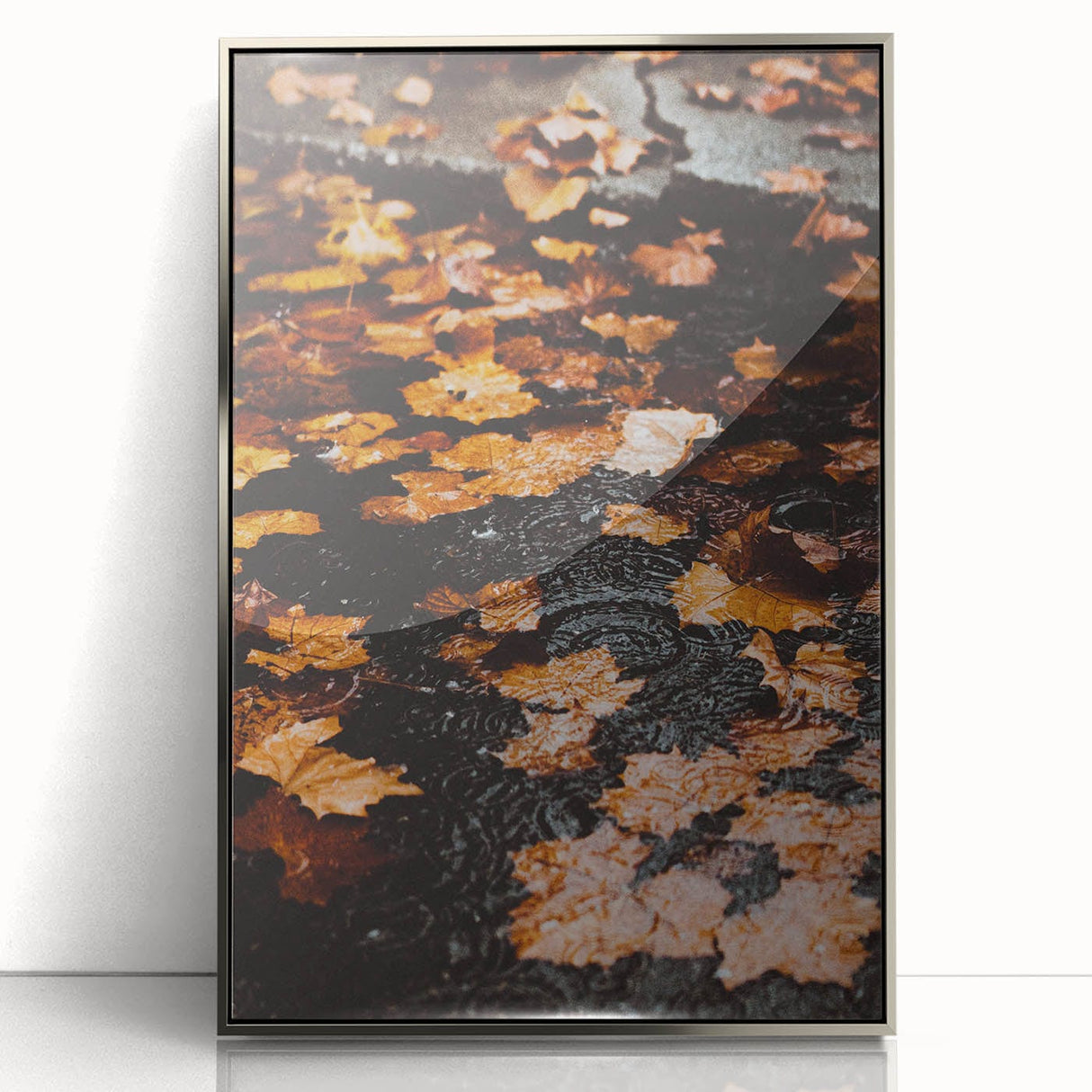 Mid-century modernist art depicting an autumn scene in muted orange and brown hues, framed in silver acrylic.