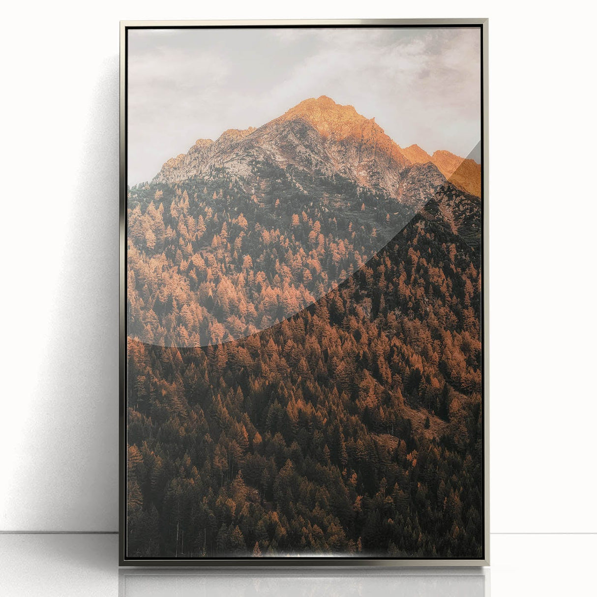 Mid-century modernist art depicting an abstract fall scene in orange and brown tones on a silver-framed acrylic print.