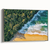 Framed landscape canvas artwork depicting a serene beach scene with soft waves and a vibrant sunset, featuring a sleek silver frame that enhances its elegance.