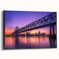 Framed canvas artwork depicting a serene landscape bridge view, showcasing lush greenery and tranquil water reflections, presented in a sleek black frame.