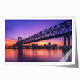 Rolled print of a landscape bridge scene, showcasing vibrant colors and detailed textures, securely packaged in a protective cardboard tube for safe shipping.
