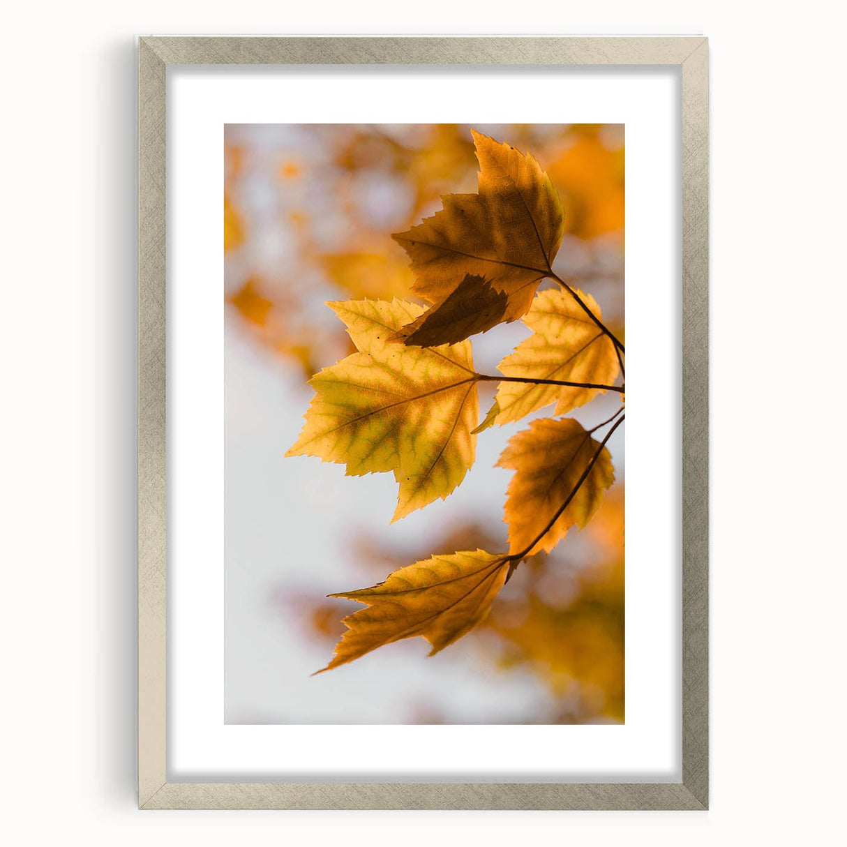 Textured abstract art print depicting autumnal hues on a silver-framed canvas, suitable for enhancing bedroom decor.