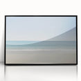 Framed acrylic wall art displaying a serene beach landscape with vibrant blues and sandy tones, encased in a sleek black frame, perfect for coastal decor.