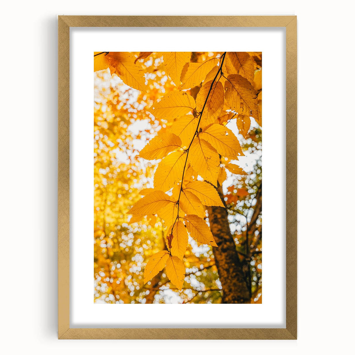 Extra large abstract art print depicting textured fall foliage in gold frame, ideal for living room wall decor.