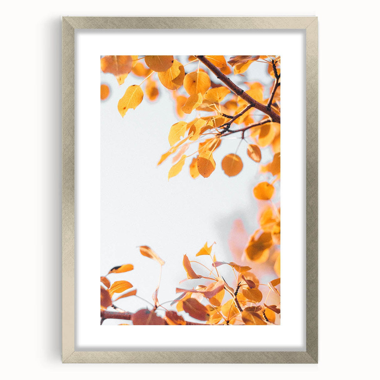 Textured abstract art print in autumn hues on a silver-framed canvas, ideal for bedroom wall decor.