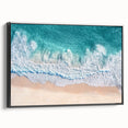 Framed canvas print showcasing a serene beach landscape with vibrant colors and intricate details, presented in a sleek black frame from a side view. Ideal for home decor.