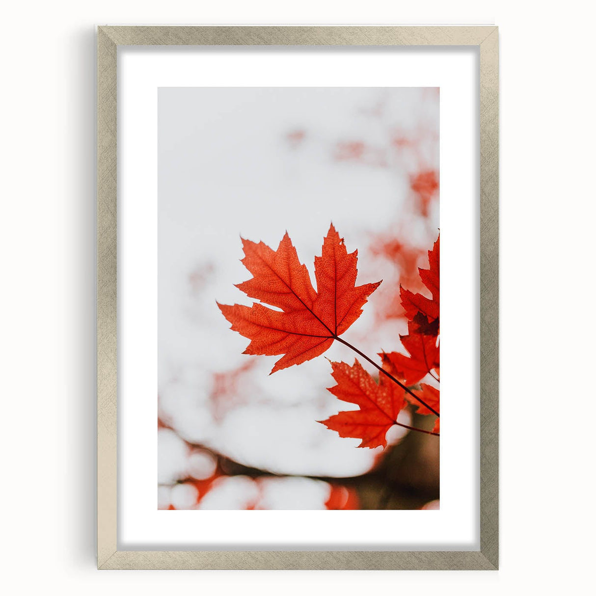 Textured abstract art print depicting autumnal hues in a silver frame, suitable for bedroom decor.