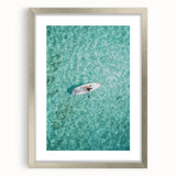 Textured abstract art print in vibrant orange and yellow hues on a silver-framed canvas, suitable for bedroom decor.
