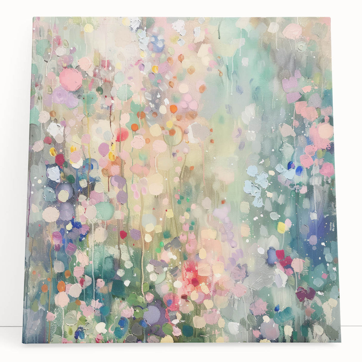 Abstract splatter art canvas featuring vibrant colors of blue, orange, and yellow, leaning against a neutral wall, perfect for contemporary home decor. This eye-catching piece adds a modern touch to any room, ideal for art enthusiasts looking to enhance their space.