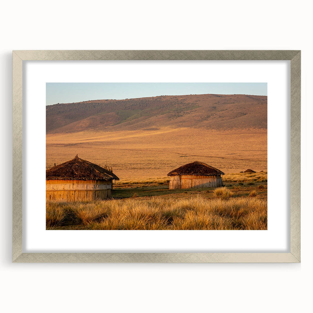 Textured abstract art print depicting a serene Tanzanian landscape in earth tones, framed in silver.