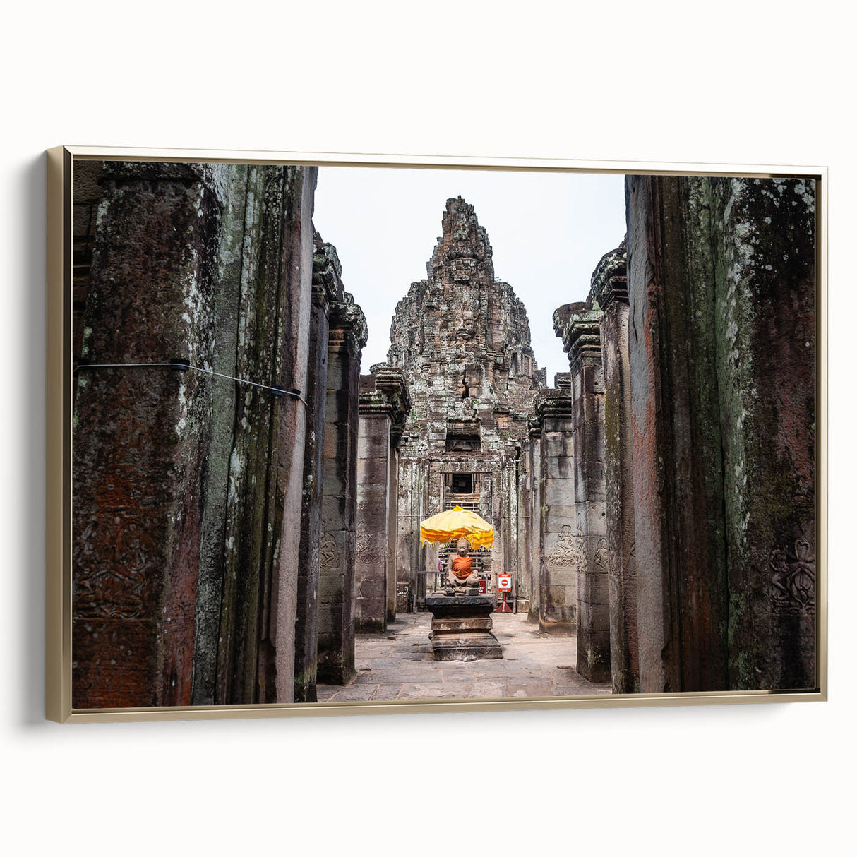 Framed canvas of a Cambodian landscape in muted gold and black tones, ideal for bedroom wall art.
