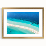 Abstract art print depicting a Caribbean seascape in vibrant blue and green tones, framed in gold.