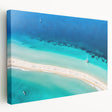Large stretched canvas depicting a serene Caribbean beach scene in soft blue and sandy hues, ideal for kitchen wall art.