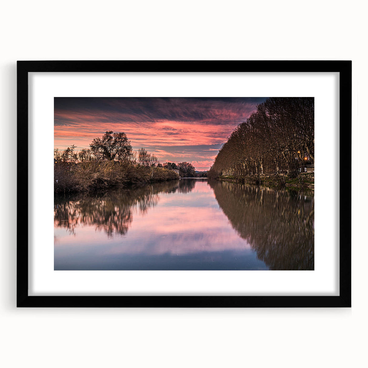 Extra large abstract art print featuring a colorful, textured scenery of Southern France, in a black frame with mat.