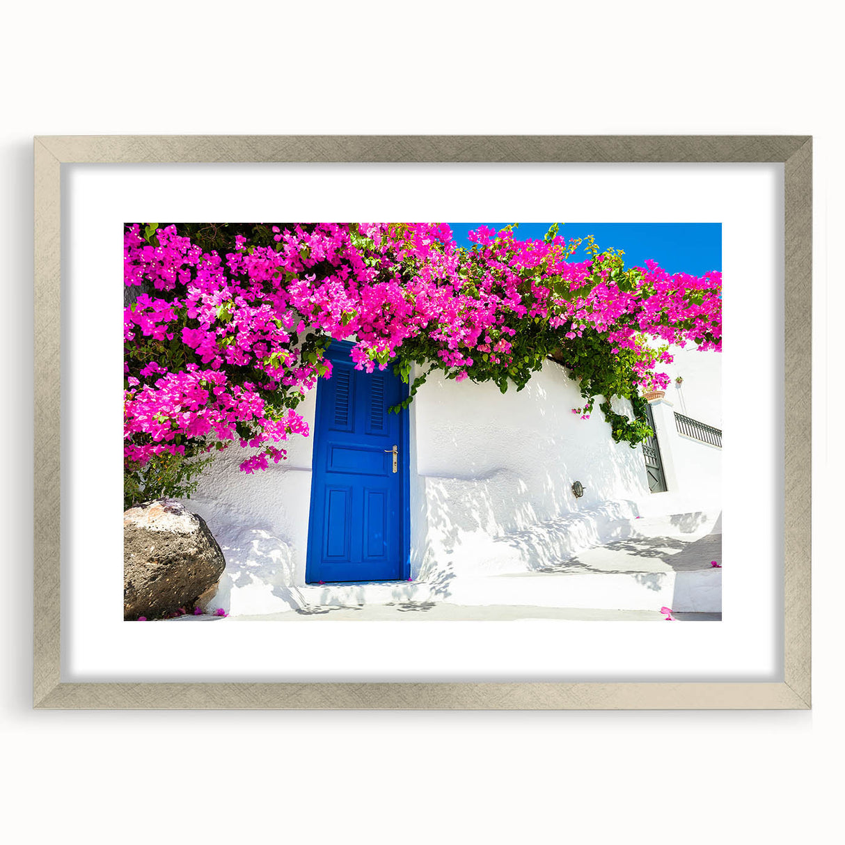 Extra large wall art featuring a textured abstract print of Santorini, Greece in blue and white tones, framed in silver.