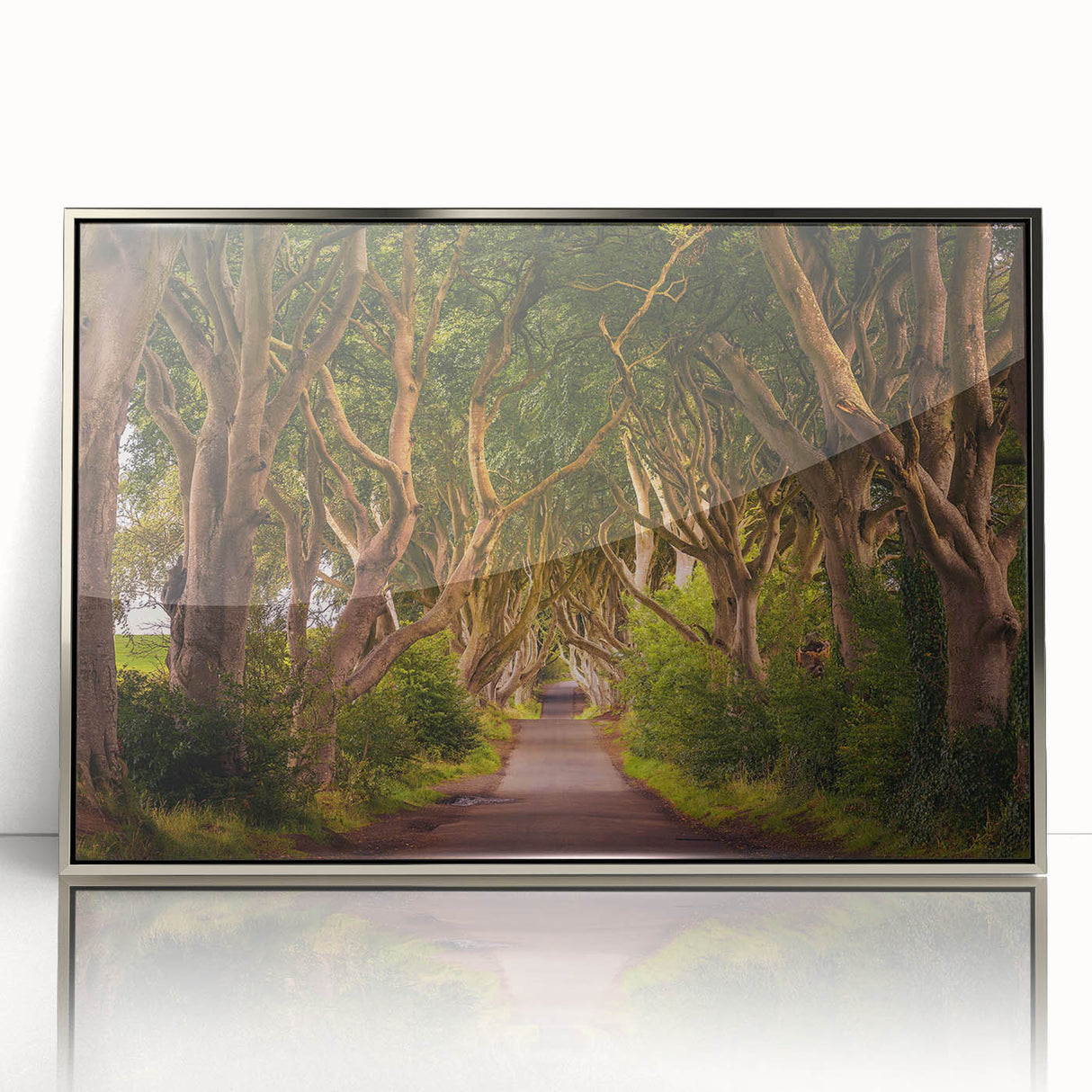 Large art print of a mid-century modernist Irish scenery in silver-framed acrylic, with muted green and earth tones.