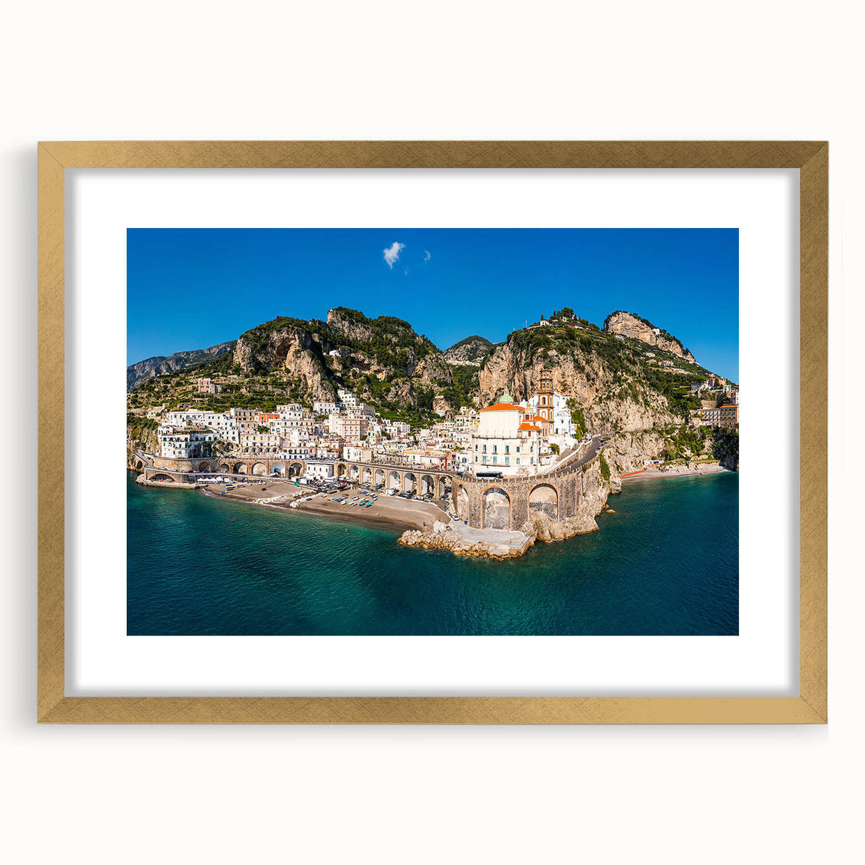 Abstract art print of the Amalfi Coast with vibrant blue and white tones on a gold-framed canvas.
