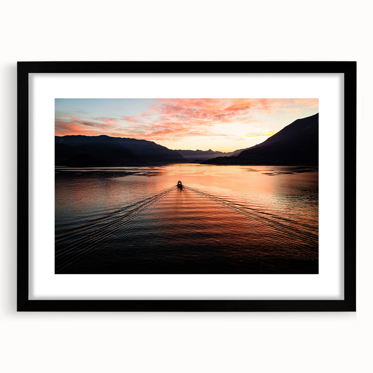 Abstract art print of Lake Como with vibrant colors and textured surface, framed in black, ideal for living room decor.