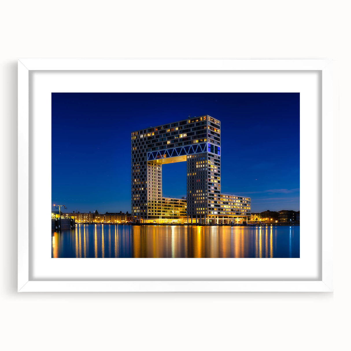 Textured art print of Amsterdam's cityscape in muted gray and blue tones on a framed white mat, ideal for bedroom decor.