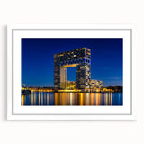 Textured art print of Amsterdam's cityscape in muted gray and blue tones on a framed white mat, ideal for bedroom decor.