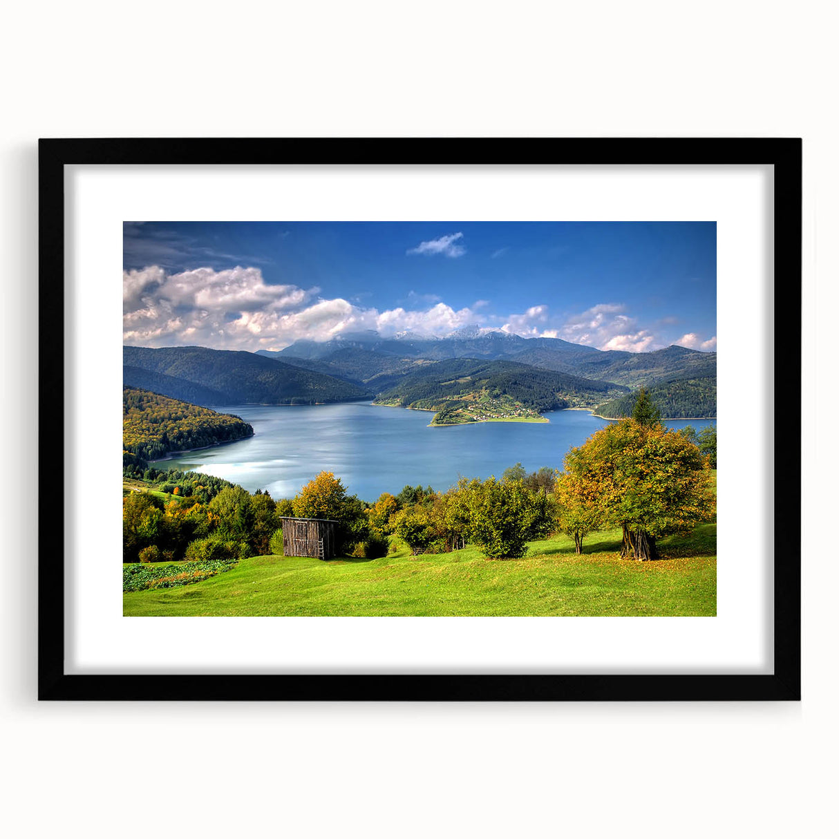 Extra large abstract art print of a colorful European scenery on a textured canvas, framed in black.