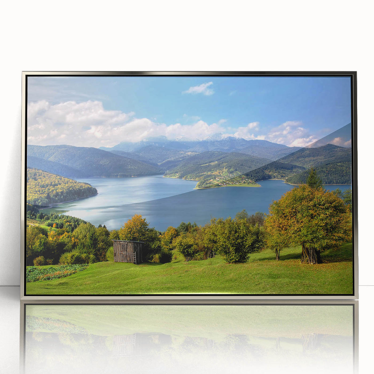 Large art print of a Romanian landscape, featuring muted earth tones on a silver-framed acrylic.
