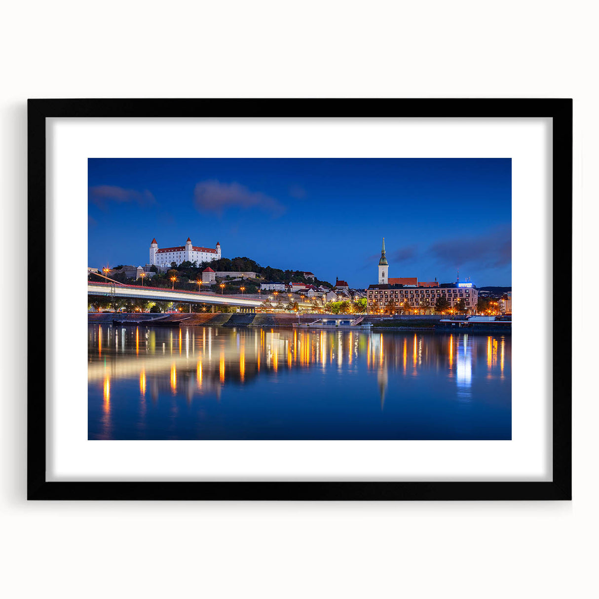Extra large abstract art print of a colorful European scenery on textured canvas, framed in black.