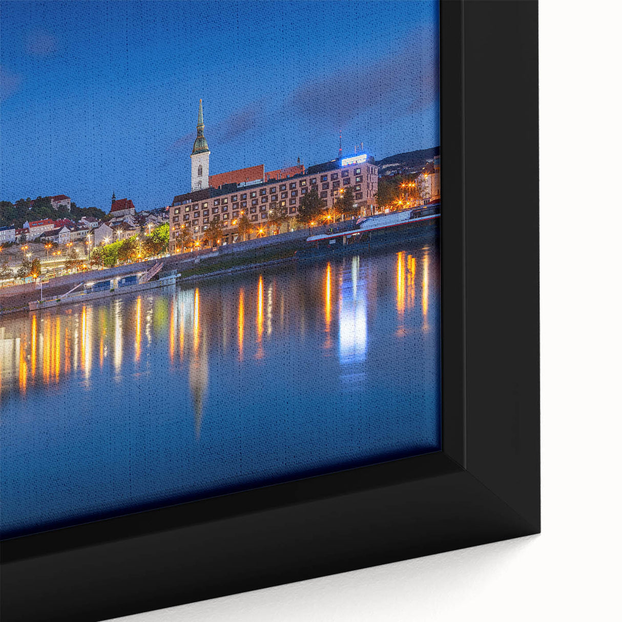 Close-up of a black framed canvas featuring a textured, colorful European scenery, ideal for living room decor.