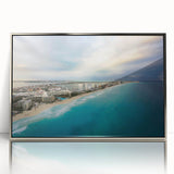 Mid-century modernist art depicting a serene Quintana Roo scenery in cool blue and green shades, silver-framed acrylic.