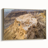 Vintage poster art of a Middle Eastern landscape on framed canvas, featuring black and gold tones.