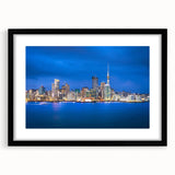 Extra large abstract art print depicting Auckland's skyline in vibrant colors on a black framed canvas.
