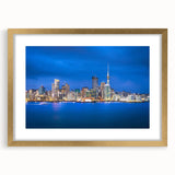 Extra large abstract art print of Auckland's skyline in textured gold frame, featuring muted earth tones.