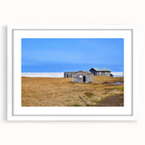 Abstract art print depicting Alaskan scenery in muted blue and gray tones on a framed white mat.