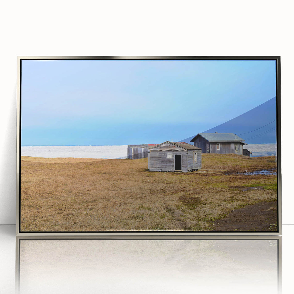Mid-century modernist art depicting Alaskan scenery in muted earth tones on a silver-framed acrylic print.