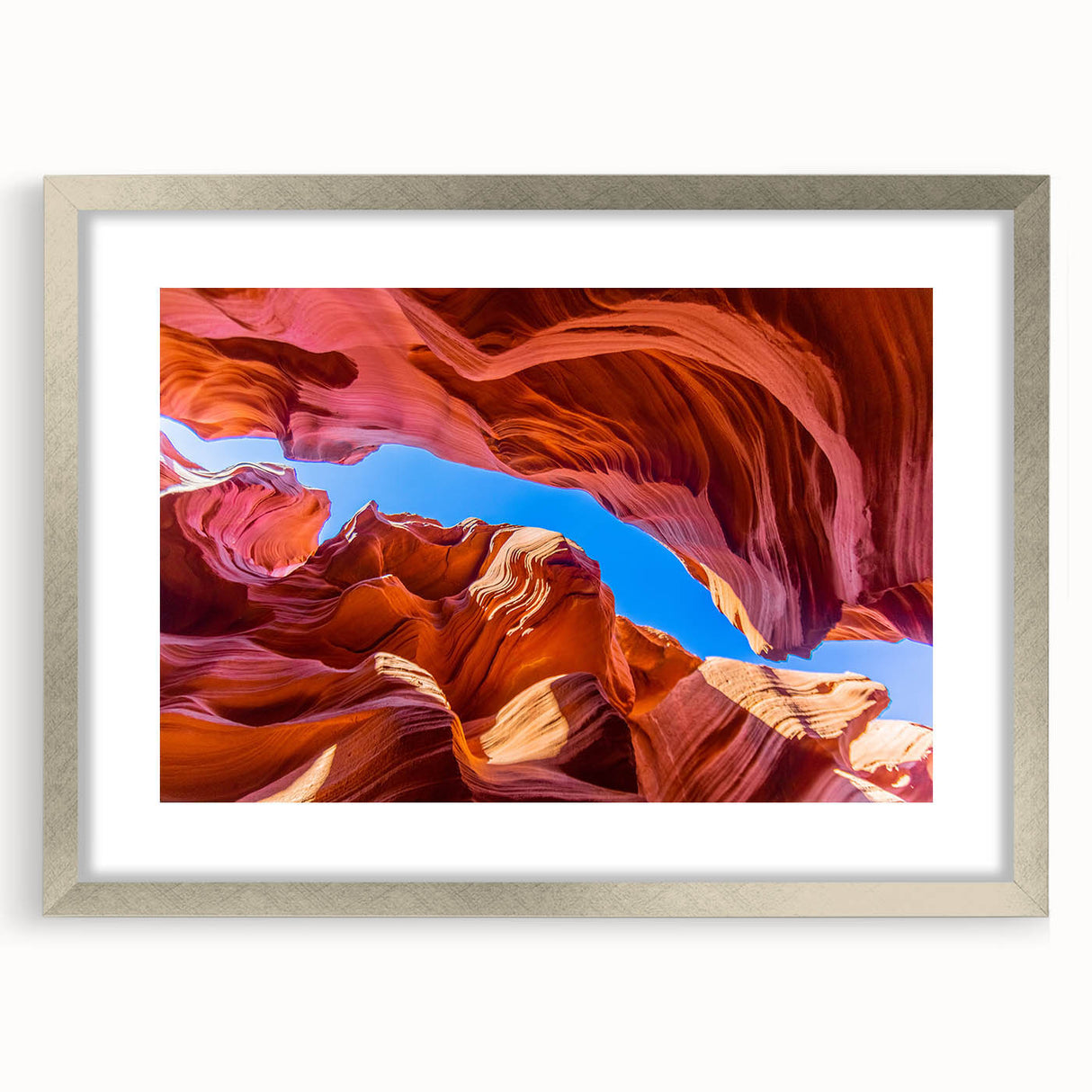 Textured art print of Antelope Canyon in Arizona, featuring earthy red and orange tones on a silver-framed mat.