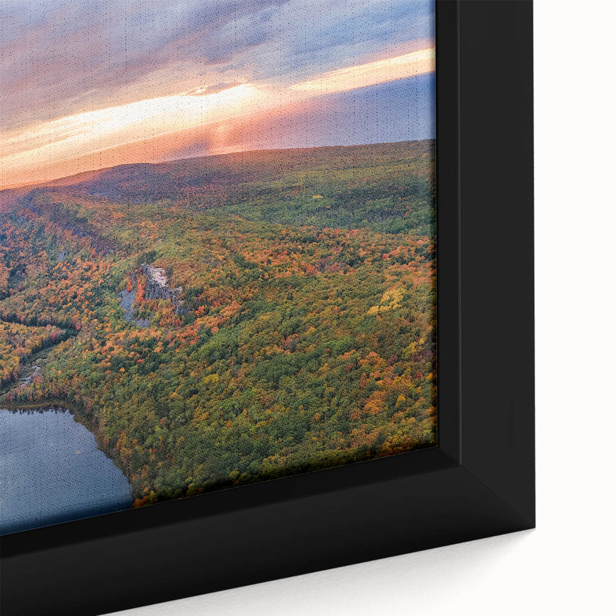 Close-up of framed canvas depicting a textured scenery of Michigan's Upper Peninsula, blending black with vibrant colors.