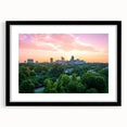 Colorful abstract art print of Raleigh skyline in vibrant hues on a large framed canvas, suitable for living room decor.