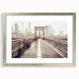 Textured art print of Brooklyn Bridge in grayscale, framed in silver, ideal for modern bedroom decor.