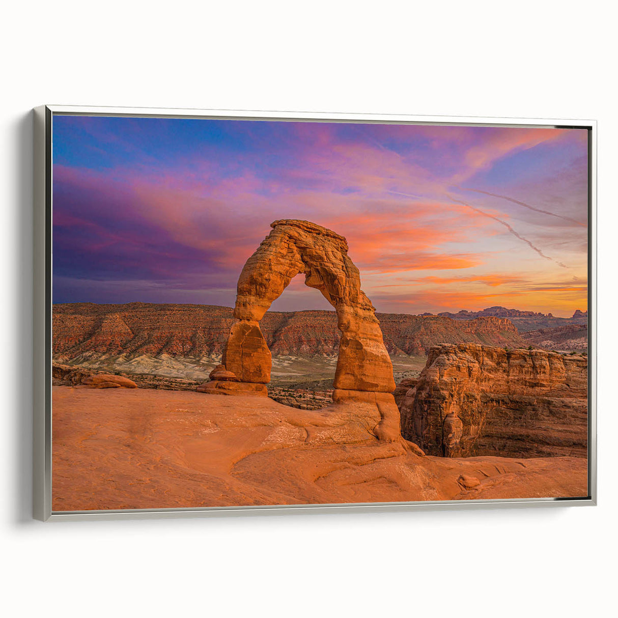 Landscape art painting of Utah Arches on a silver-framed canvas, featuring earthy red and orange tones.
