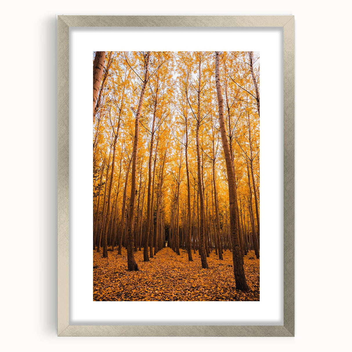 Textured abstract art print in earthy orange and brown tones, framed in silver, ideal for bedroom ambiance.