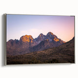 Framed canvas artwork showcasing a dramatic landscape of cliffs, featuring a silver frame and a side view that highlights its elegant design for modern decor.