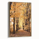 Framed canvas depicting a vintage landscape painting with autumnal trees and muted gold and black tones.