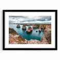 Black-framed landscape artwork depicting dramatic cliffs and ocean waves, elegantly matted for a sophisticated presentation in home decor.