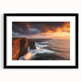 Black-framed landscape artwork depicting majestic cliffs under a vibrant sunset, featuring a white mat for a polished presentation, ideal for home decor.