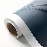 Rolled canvas artwork depicting a serene landscape bridge scene, showcasing vibrant colors and intricate details, packaged securely in a protective cardboard tube.