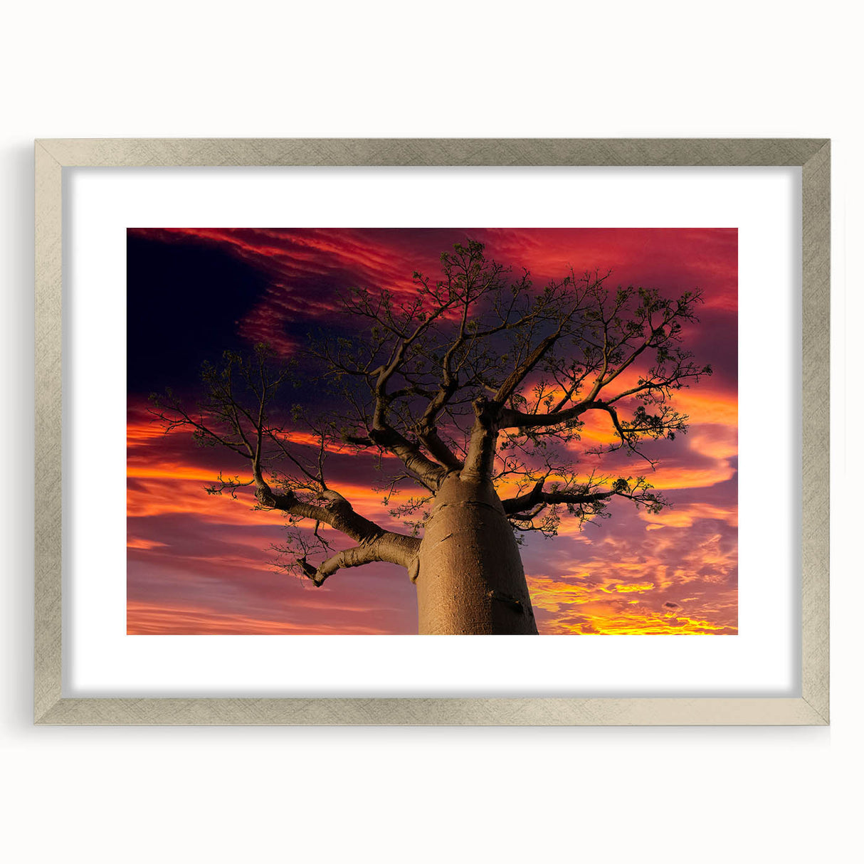 Abstract art print of Madagascar scenery in muted earth tones on a framed silver canvas, suitable for dining room decor.